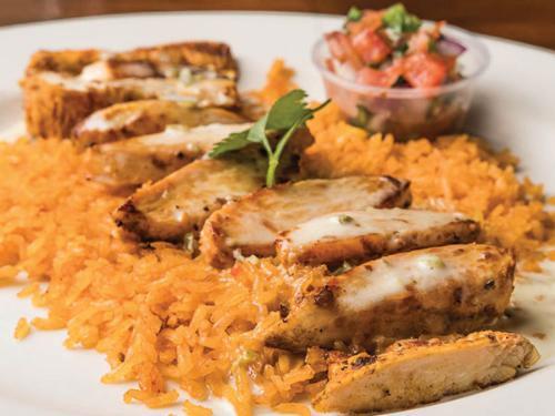 Huasteco · Choose seasoned grilled chicken, steak or shrimp, served over a bed of rice, topped with queso and pico.