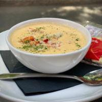 Lobster Bisque · Creamy and salty bisque flavored by Maine lobster and topped with picked lobster meat.