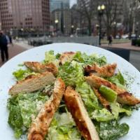 Caesar Salad · Chopped Romaine hearts, herb-garlic croutons, grated Parmesan, and house-made Caesar dressing.