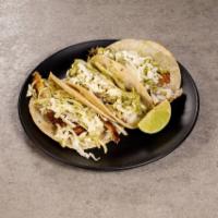 Fish Tacos · 3 grilled Tilapia corn tortilla tacos topped with avocado cream slaw, queso fresco and serve...