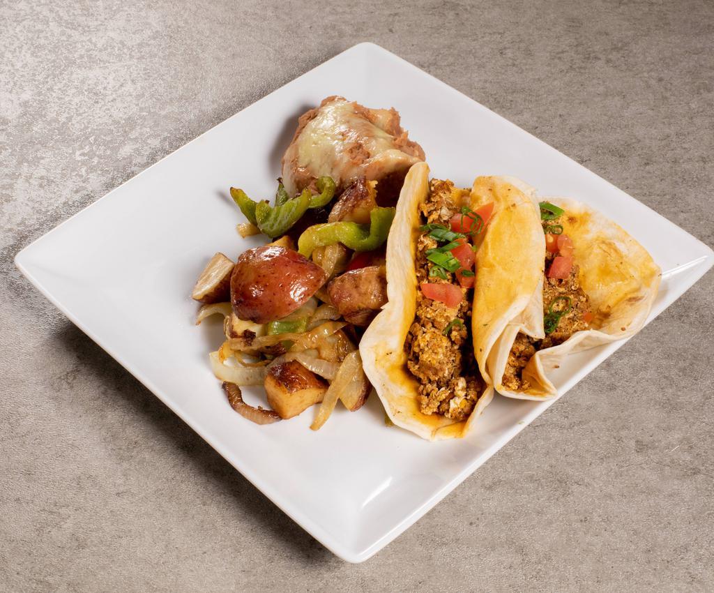 Breakfast Tacos · 2 flour tortillas filled with scrambled eggs, bacon or chorizo sausage and shredded cheese served with refried beans and papas fritas.