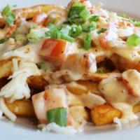 Crawfish Poutine · Crawfish Étouffée, melted mozzarella cheese, and green onions over fries.