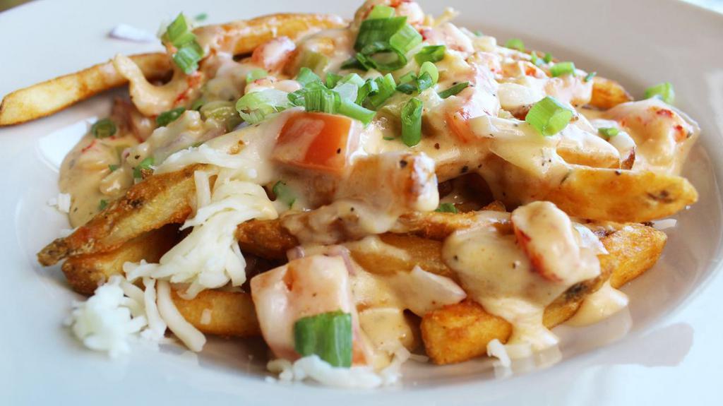 Crawfish Poutine · Crawfish Étouffée, melted mozzarella cheese, and green onions over fries.