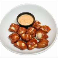 Pretzel Bites with Beer Cheese · Gourmet pretzel bread bites, brushed with our roasted garlic olive oil, served with our hous...