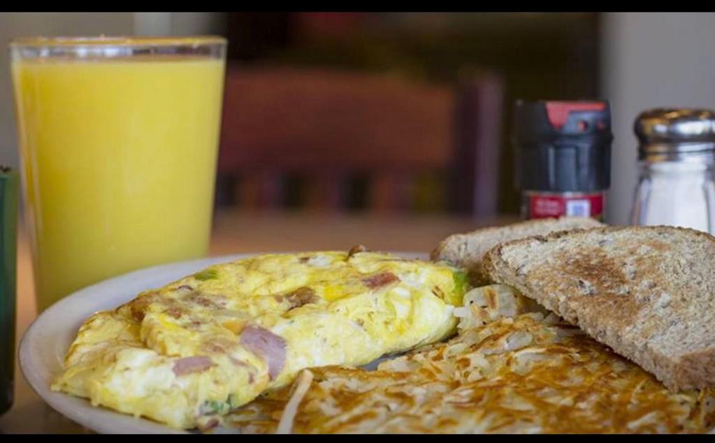 Western Omelette Breakfast · 3 eggs mixed with ham, American cheese, green peppers and onion. Served with hash browns or pancakes and choice of toast.