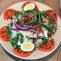 Clubhouse Salad · Topped with oven roasted turkey, chopped bacon, Swiss cheese, hard-boiled egg, onions, green...