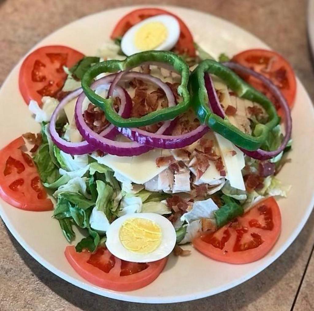 Clubhouse Salad · Topped with oven roasted turkey, chopped bacon, Swiss cheese, hard-boiled egg, onions, green peppers and tomatoes.