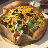 Super Taco Salad · Tossed lettuce, seasoned ground beef or grilled chicken with tomatoes, olives, onions, green...