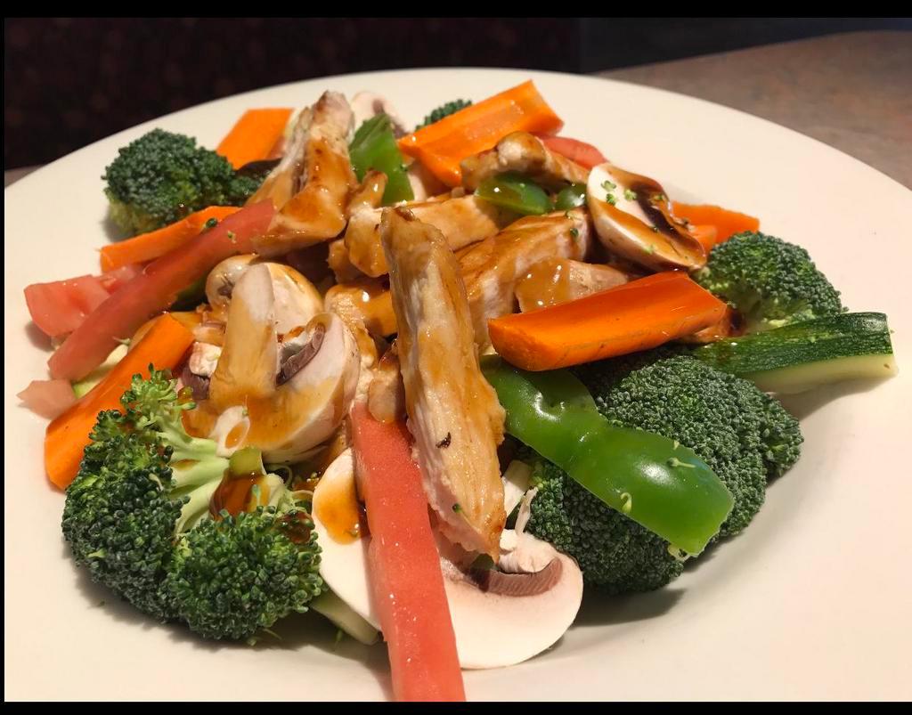 Chicken Breast Stir-Fry · Chicken breast, fresh broccoli, zucchini, onions, peppers, carrots and mushrooms sauteed with teriyaki sauce and served rice pilaf.