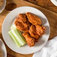Voodoo Chicken Strips · Seasoned and battered chickens strips tossed in our made 
from scratch Voodoo Sauce, and ser...