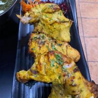 Tandoori Chicken · Tender pieces of chicken on the bone marinated with spices and a ginger garlic paste. 