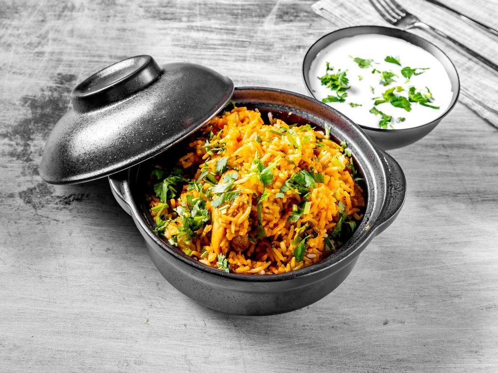 Murgh Biryani · A mixture of chicken & basmati rice cooked with fresh herbs & spices served with raita.
