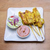 4.Chicken Satay · Grilled marinated chicken. Served with peanut sauce and cucumber salad.