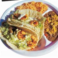 2 Shrimp Tacos combo · Includes Rice, Beans , Lettuce , Sour Cream & Free 16 oz drink