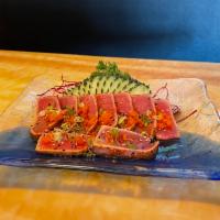 Tuna Tataki · Lightly fried chili tuna , thinly slice tuna on base daikon 
Serve with ponzu sauce, Masago ...
