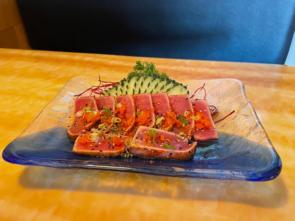 Tuna Tataki · Lightly fried chili tuna , thinly slice tuna on base daikon 
Serve with ponzu sauce, Masago and green onion 