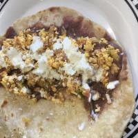 Baleadas with Meat · Homemade flour tortilla, scrambled eggs, beans, Salvadorian cream, and Parmesan cheese. Choi...