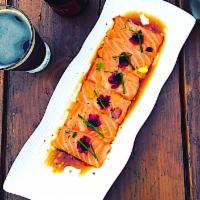 Salmon Carpaccio Sashimi (6 pcs) · Salmon sashimi topped with garlic, cilantro, jalapeno and yuzu vinaigrette. Spicy.