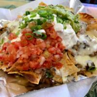 Supreme Nacho · Chips covered with beans, cheese, delicious salsa topped with sour cream, fresh guacamole an...