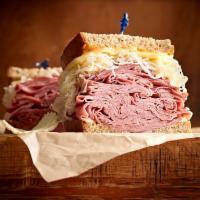 Reuben the Great Sandwich · 1/2 lb. of hot corned beef or pastrami, Swiss, sauerkraut, Thousand Island dressing, grilled...