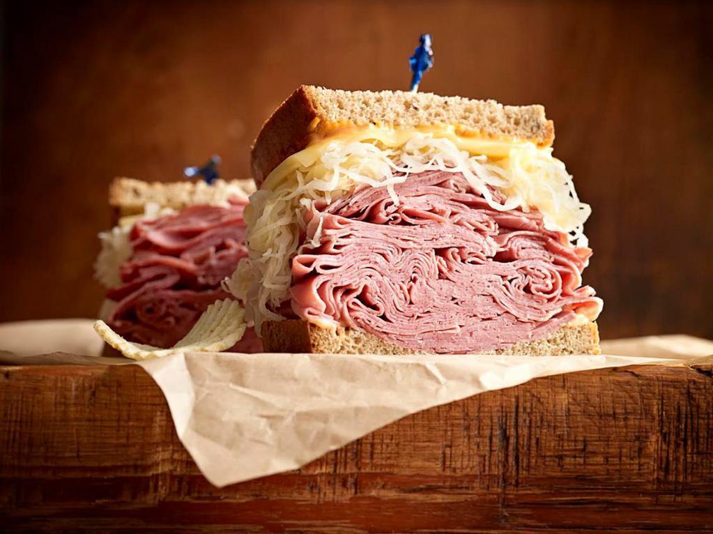 Reuben the Great · 1/2 lb. of hot corned beef or pastrami, Swiss, sauerkraut, 1000 Island dressing and grilled rye.