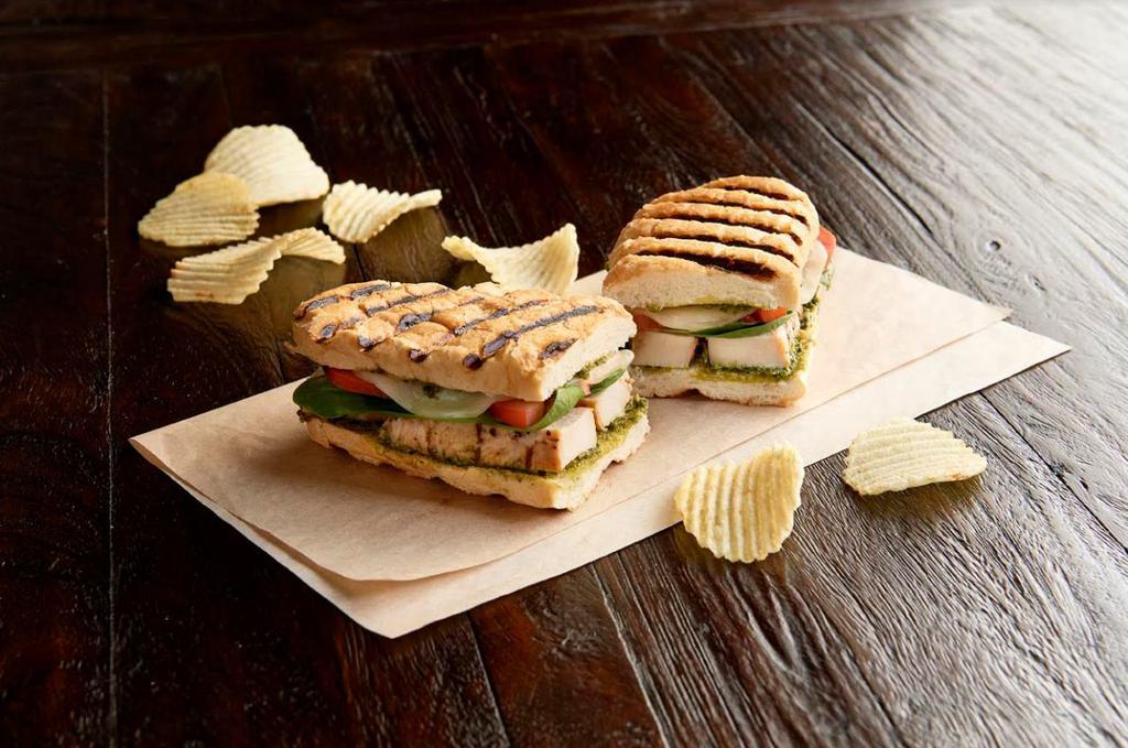 Sourdough Chicken Panini · Grilled. 100% antibiotic-free chicken breast, provolone, pesto aioli, Roma tomatoes, organic spinach and New Orleans French Bread.