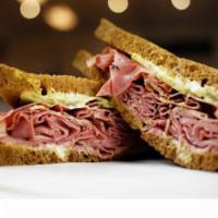 16. Hot Pastrami Sandwich · Pestrami, Dijon, honey musterd, onions pickles, tomato and Swiss cheese.