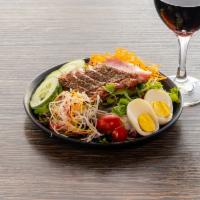 Seared Tuna Salad · Spring mix, cherry tomatoes, cucumbers, carrots, daikon, egg, wasabi peas and honey yuzu vin...