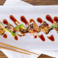 Eel Avocado Roll · 8 pieces. California roll base with baked eel, avocado, eel sauce, and sesame seed on top.