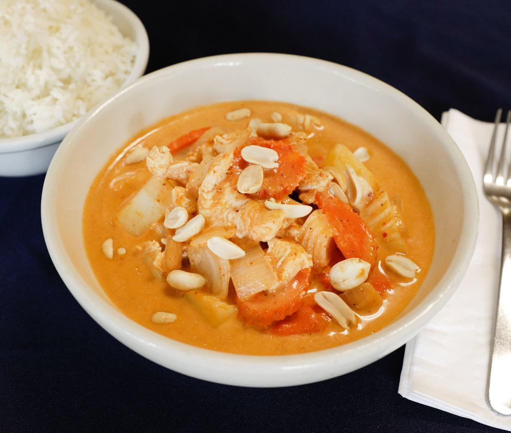 31. Gang Massaman · Medium spicy massaman curry with tamarind juice coconut milk, potatoes, carrots, onion and peanuts. Includes rice.