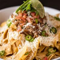 Great American Nachos · Cheese sauce, serranos, pico, green onions, cilantro, Cotija and lime. Add meat and add avoc...