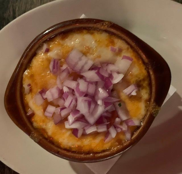 Chili Con Carne · Tasty chili topped with red onions and melted cheese
