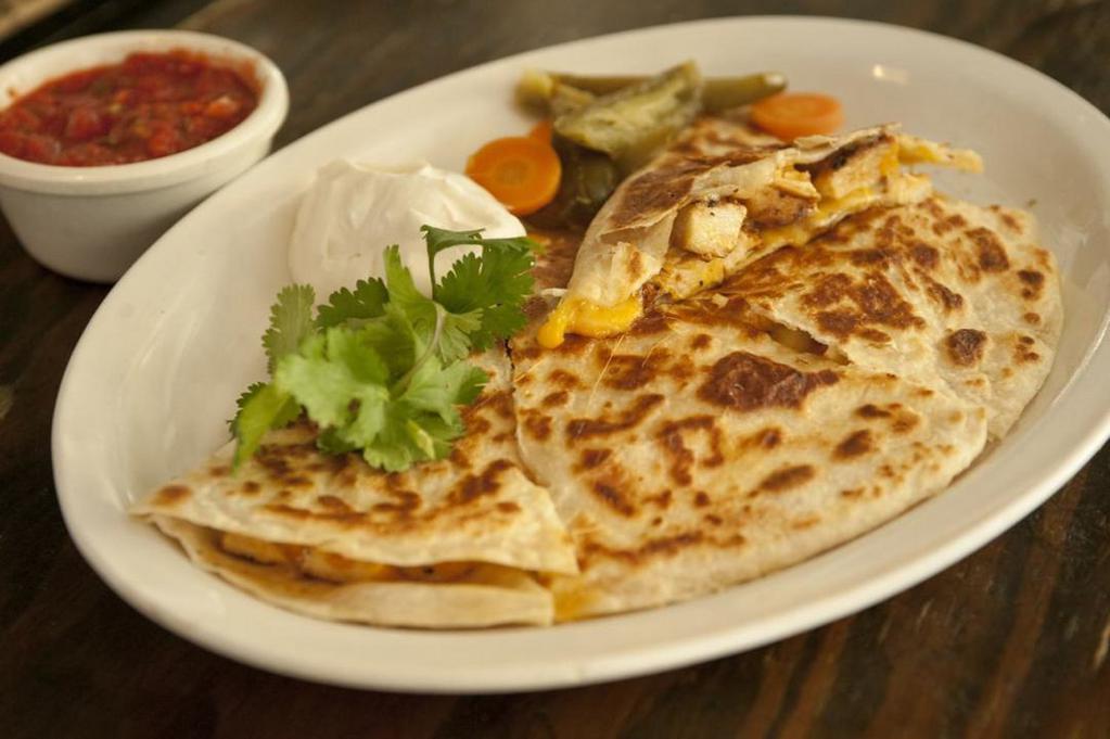 Quesadilla con Pollo · Grilled folded soft flour tortilla filled with melted cheddar cheese and juicy grilled chicken served with sour cream and jalapeño peppers