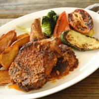 D Chipotle Chuleta · Chipotle breaded, slow baked pork chops served with Mexican fries and grilled vegetables (sp...