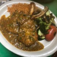 D Chuleta En Salsa Verde · Grilled pork chop topped with mildly spicy green sauce. Served with grilled vegetables and M...