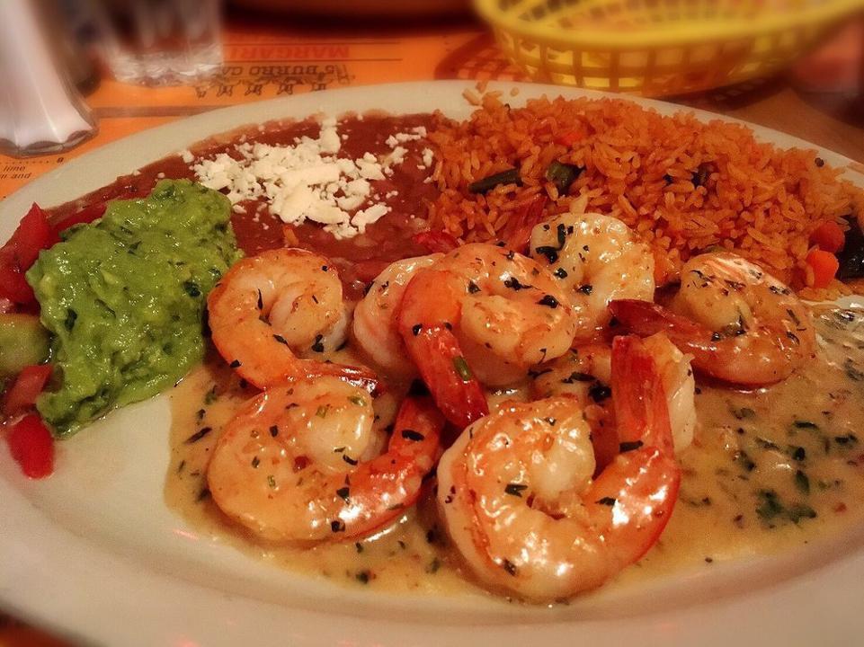 D Camarones Al Ajillo · Sautéed jumbo shrimp in white wine garlic sauce served with rice, beans, guacamole and pico de gallo.