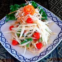 Vegetarian Papaya Salad · A classic Thai-style green papaya salad with palm suga, lemon juice, cherry tomatoes, string...