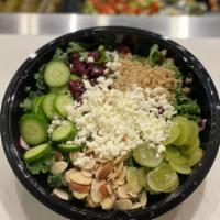 Superfood Kale Salad · Fresh kale, quinoa, toasted sliced almonds, cranberries, grapes, cucumber & feta cheese with...