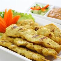 CHICKEN SATAY · Marinated chicken served with a classic peanut sauce and cucumber chutney.