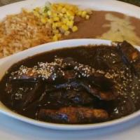 Mole Con Pollo Speciality · Grilled chicken covered with mole served with rice and beans.