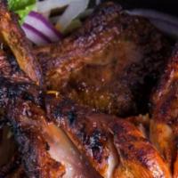 Tandoori Chicken  · Grilled bone-in chicken marinated in yogurt, garlic, ginger and fresh ground spices.