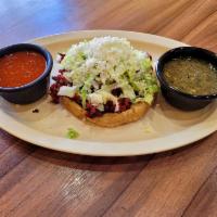 Sopes con Carne · With meat.

Comes with , beans , lettuce , sour cream , fresh cheese and choice of meat