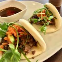 BB2. Grilled Pork Bao Bun · 3 pieces Bao bun with grilled pork, jalapeno, carrot pickled and cilantro.  Service with pea...