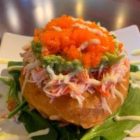 Sushi Donut · Hand-crafted with white sticky rice with cream cheese in the middle topped with crab mix, av...