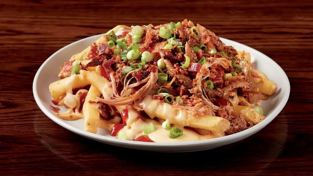 Pulled Pork Poutine · Chef Paul's interpretation of Canadian poutine crispy Yukon french fries, bacon, pulled pork, chipotle mayo, BBQ sauce, and cheese sauce.  1470 calories.