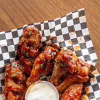 Crispy Chicken Wings · Six piece crispy chicken wings tossed in a house made sauce of your choice.