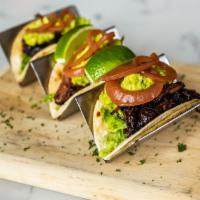 Short Rib Tacos · Guacamole, chopped lettuce, pickled red onions, shaved radish and pepper jack cheese.