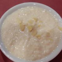 Rice Pudding · Rice pudding cooked with milk and topped with nuts and saffron and served hot or cold.