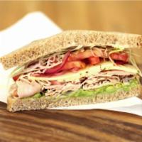 Baja Chipotle Turkey Sandwich · Turkey breast with a chipotle honey lime yogurt sauce,
shaved cabbage, pickled red onions, t...