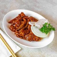 Maeun Doeji Kalbi 매운 돼지갈비 · Spicy marinated grilled pork ribs.